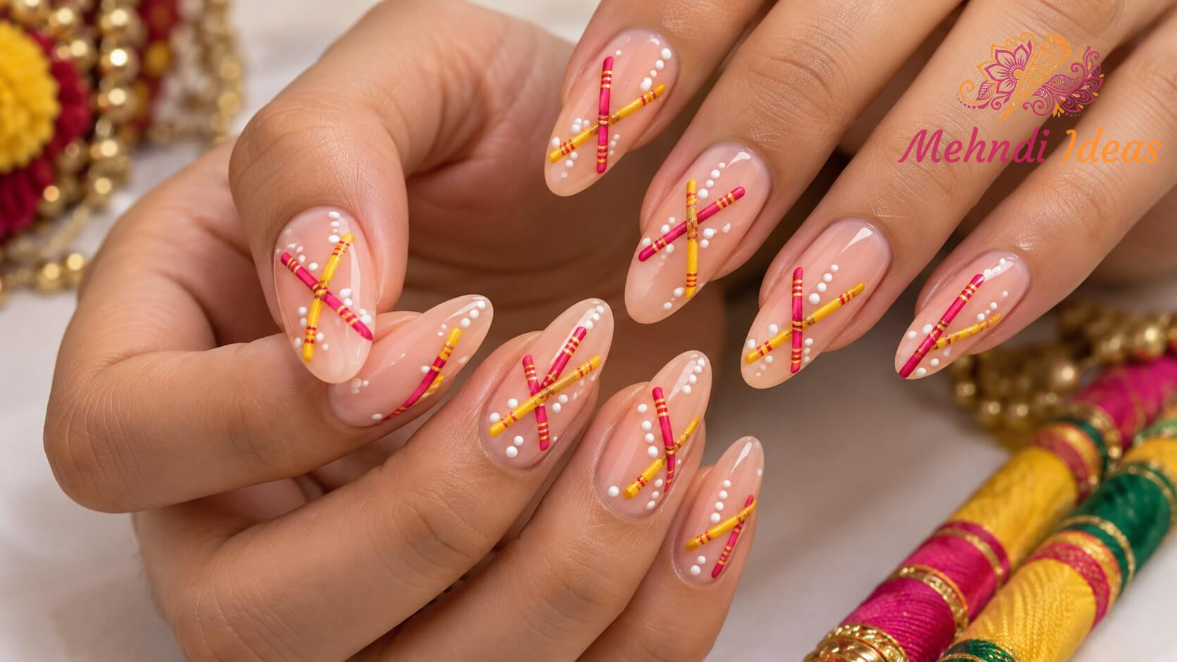 Pink and yellow Dandiya cross accent nail art for Navratri